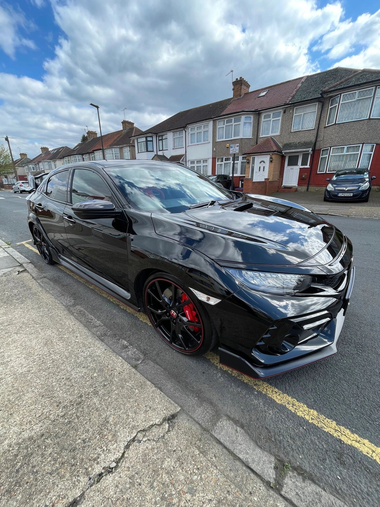 Detailed black Honda Civic reflecting the sky