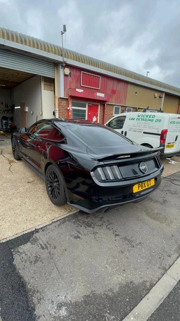 Black Ford Mustang outside the detailing workshop